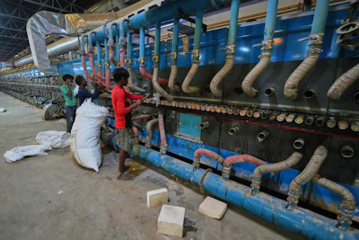 Workers perform maintenance on a machine at a shuttered ceramic factory in Morbi in the Indian state of Gujarat, Wednesday, April 8, 2026.