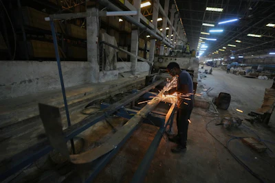 A man performs maintenance work on a machine at a shuttered ceramics factory following a fuel shortage, in Morbi in the Indian state of Gujarat, Wednesday, April 8, 2026.