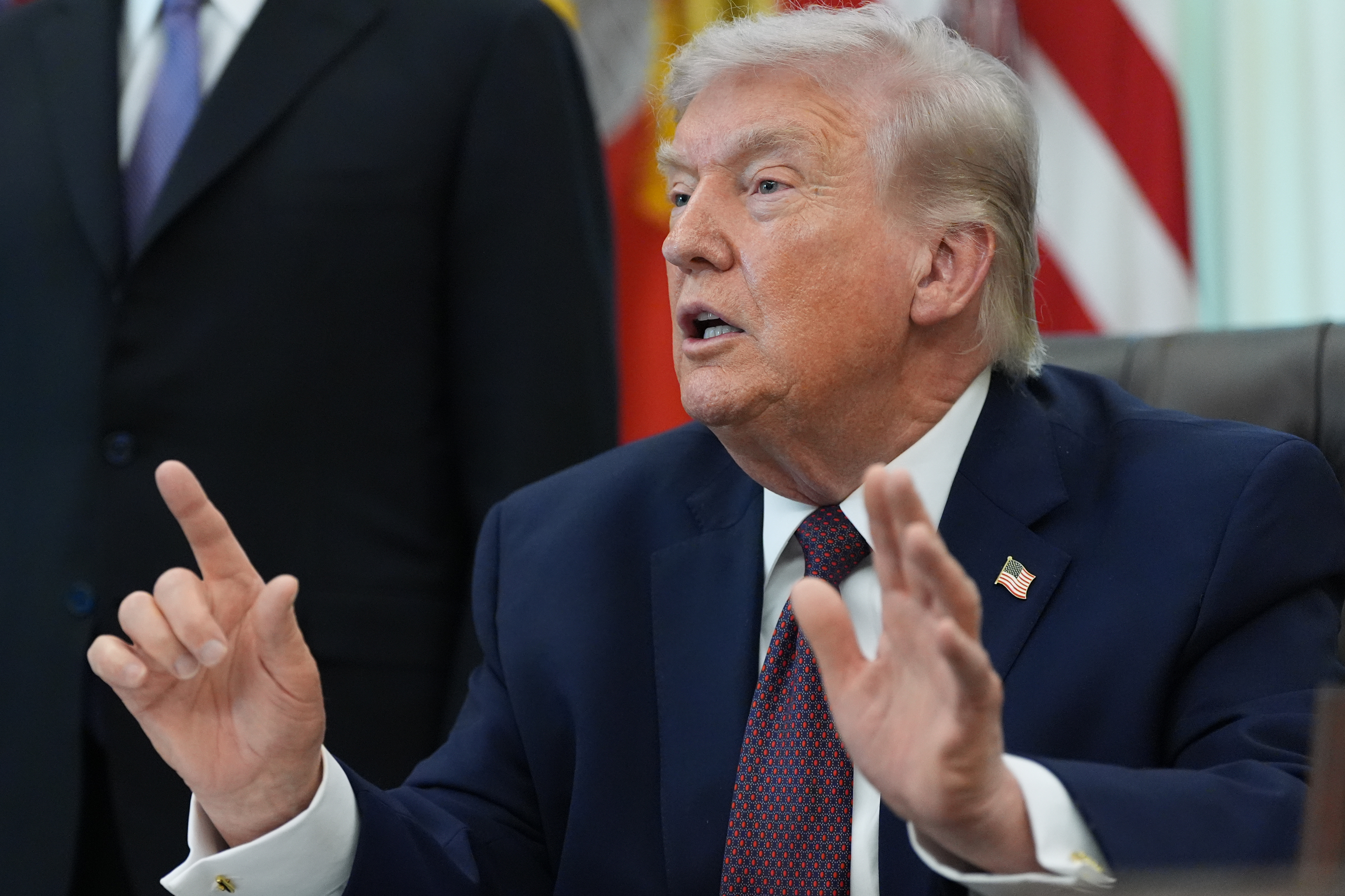 President Donald Trump answers questions from reporters after signing an executive order in the Oval Office of the White House Tuesday, March 31, 2026, in Washington.