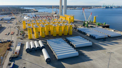 Wind turbine bases, generators and blades are positioned along with support ships at The Portsmouth Marine terminal at the staging area for Dominion Energy's wind turbine project Monday Dec. 22, 2025, in Portsmouth, Va.