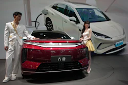 Models stand next to a latest EV car from Chinese automaker BYD showcased at the Auto China 2026, in Beijing, Saturday, April 25, 2026.