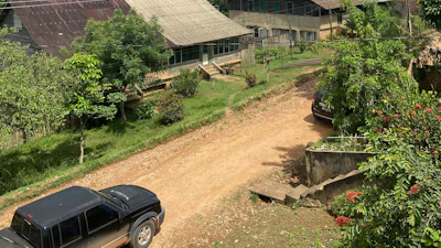 This photo provided by the Brazilian Federal Justice shows a truck driving past buildings in Fordlandia, Para, Brazil, Dec. 6, 2021.