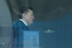 Elon Musk walks through a hallway inside the U.S. District Court in Oakland, Calif., Wednesday, April 29, 2026.