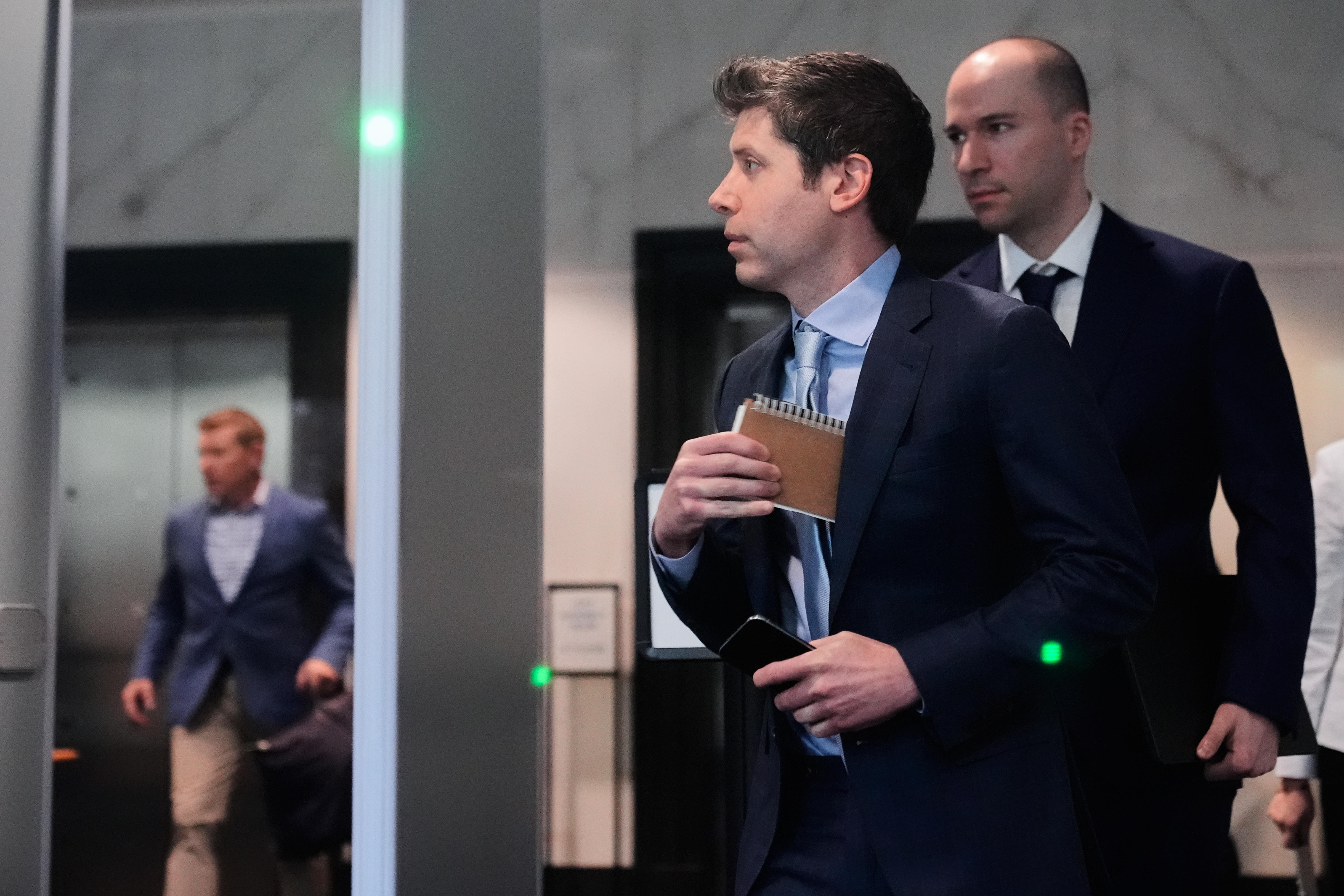 Sam Altman, center, and OpenAI president Greg Brockman, right, arrive at the U.S. District Court in Oakland, Calif., Thursday, April 30, 2026.