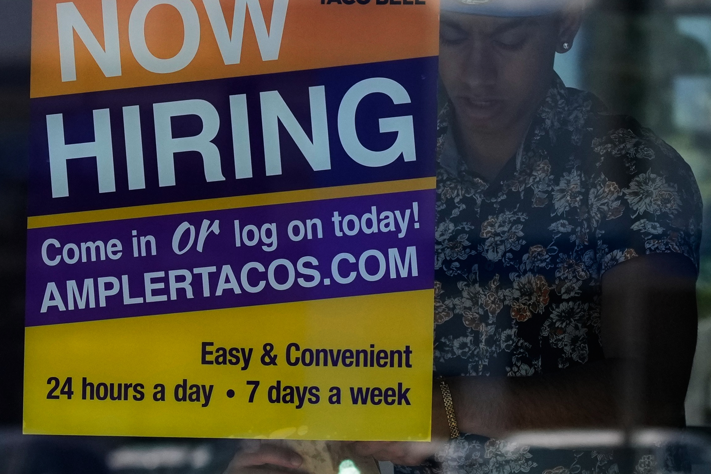 A hiring sign is displayed at a restaurant in Niles, Ill., Thursday, May 14, 2026.