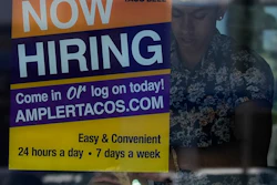 A hiring sign is displayed at a restaurant in Niles, Ill., Thursday, May 14, 2026.