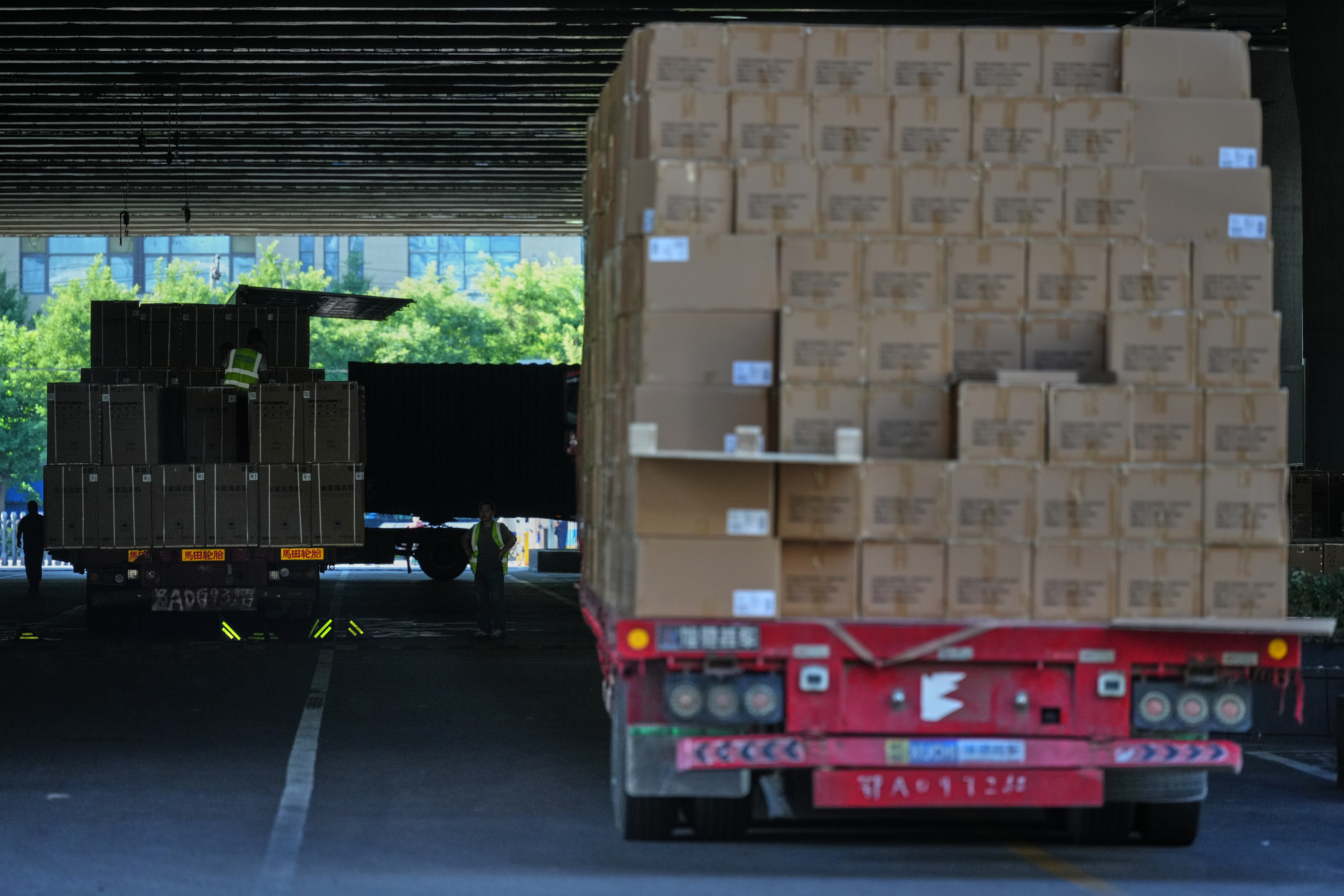 Workers transfer goods from a truck at the Xiaomi logistic center, Beijing, May 29, 2026.