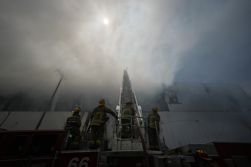 Firefighters fight a warehouse fire in the Boyle Heights neighborhood of Los Angeles, Sunday, June 21, 2026.