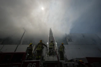 Firefighters fight a warehouse fire in the Boyle Heights neighborhood of Los Angeles, Sunday, June 21, 2026.