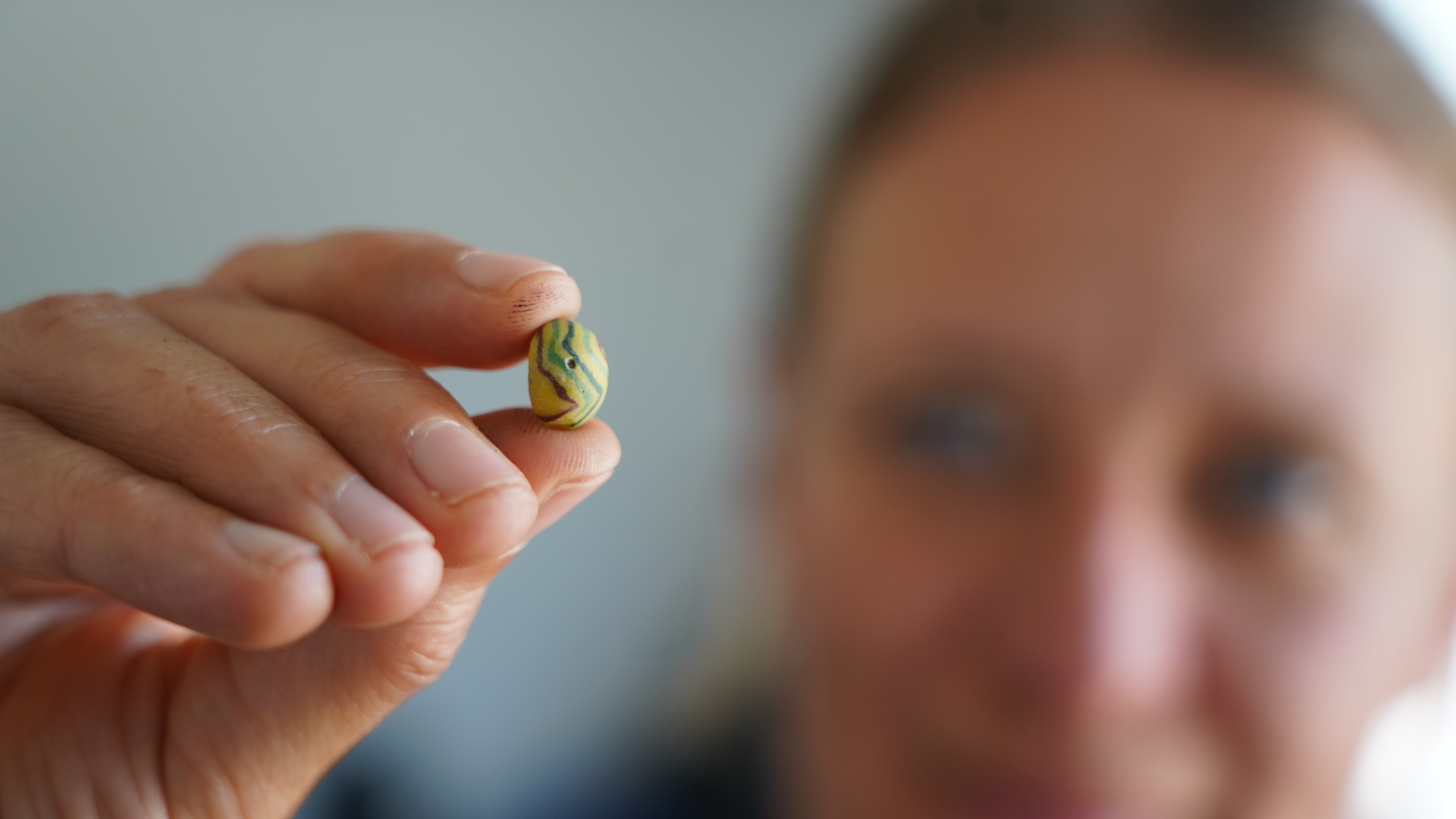 Moesgaard Museum archaeologist Liv Stidsing Reher-Langberg holds a Viking Age glass bead unearthed in Aarhus, Denmark, on June 22, 2026.