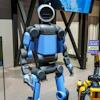 Boston Dynamics received a $25 million award to fund projects tied to manufacturing, workforce training and operations for the company’s Atlas (left), Spot (lower right) and Stretch platforms.