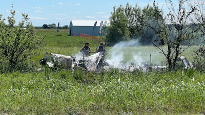 The wreckage of a plane crash burns in a field in Butler, Mo, Sunday, June 14, 2026.