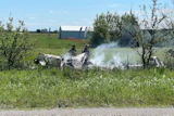 The wreckage of a plane crash burns in a field in Butler, Mo, Sunday, June 14, 2026.