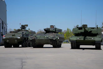 A boxer armoured personnel carrier, from left, a Puma infantry fighting vehicle and a Leopard battle tank are displayed during the opening of a new production line production line of Boxer 8x8 wheeled armoured personnel carrier produced by pan-European defense company KNDS in Munich, Germany, on April 22, 2026.