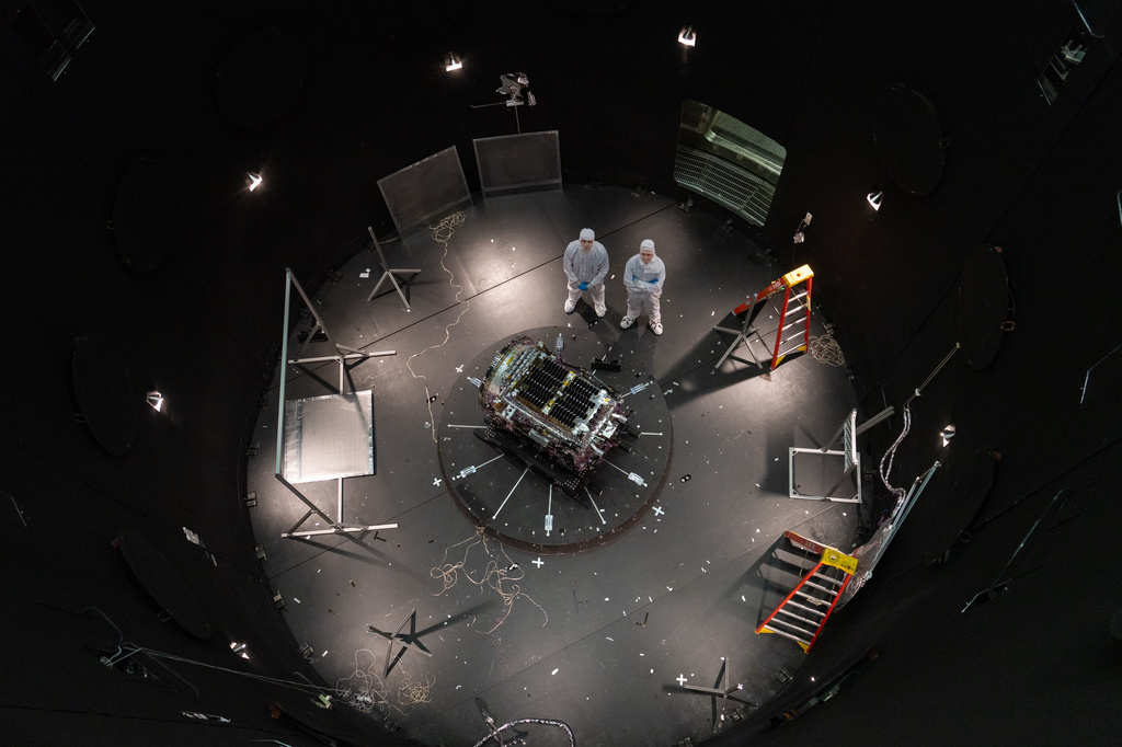 This photo provided by NASA shows Kieran Wilson, LINK&rsquo;s principal investigator, and Hunter Robertson, a space systems engineer, both at Katalyst Space, standing next to their spacecraft inside the SES (Space Environment Simulator) at NASA&rsquo;s Goddard Space Flight Center in Greenbelt, Md., April 17, 2026, ahead of thermal vacuum testing.