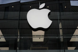 The Apple logo is illuminated at a store in Munich, April 2, 2026.