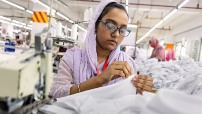 Ruma Aktar, a sewing machine operator, wears her prescription eyeglasses while working at a garment factory in Gazipur, on the outskirts of Dhaka, Bangladesh, June 30, 2026.