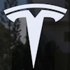The Tesla logo is displayed at a Tesla dealership, Mar. 13, 2025, in Miami.