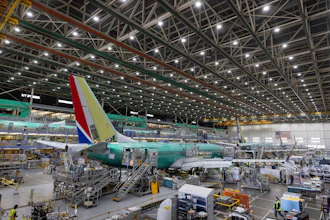 Boeing employees work on a 737 MAX airplane on the final assembly line at Boeing's plant in Renton, Wash., on June 15, 2022.