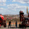 Salesmen walk among agricultural machinery displayed at an equipment dealership, Brasilia, Brazil, July 22, 2026.