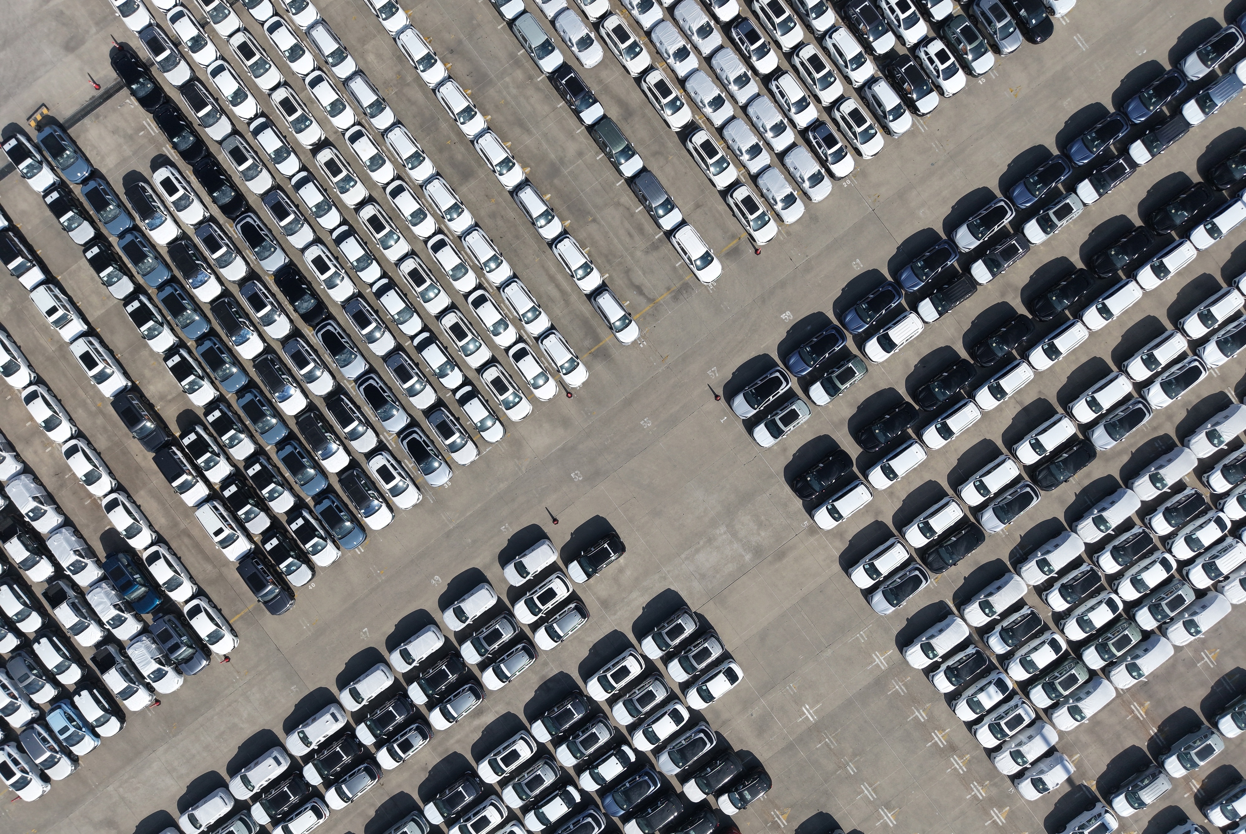 An aerial view of new cars awaiting export to oversea markets is seen at a port in Shanghai, March 10, 2026.
