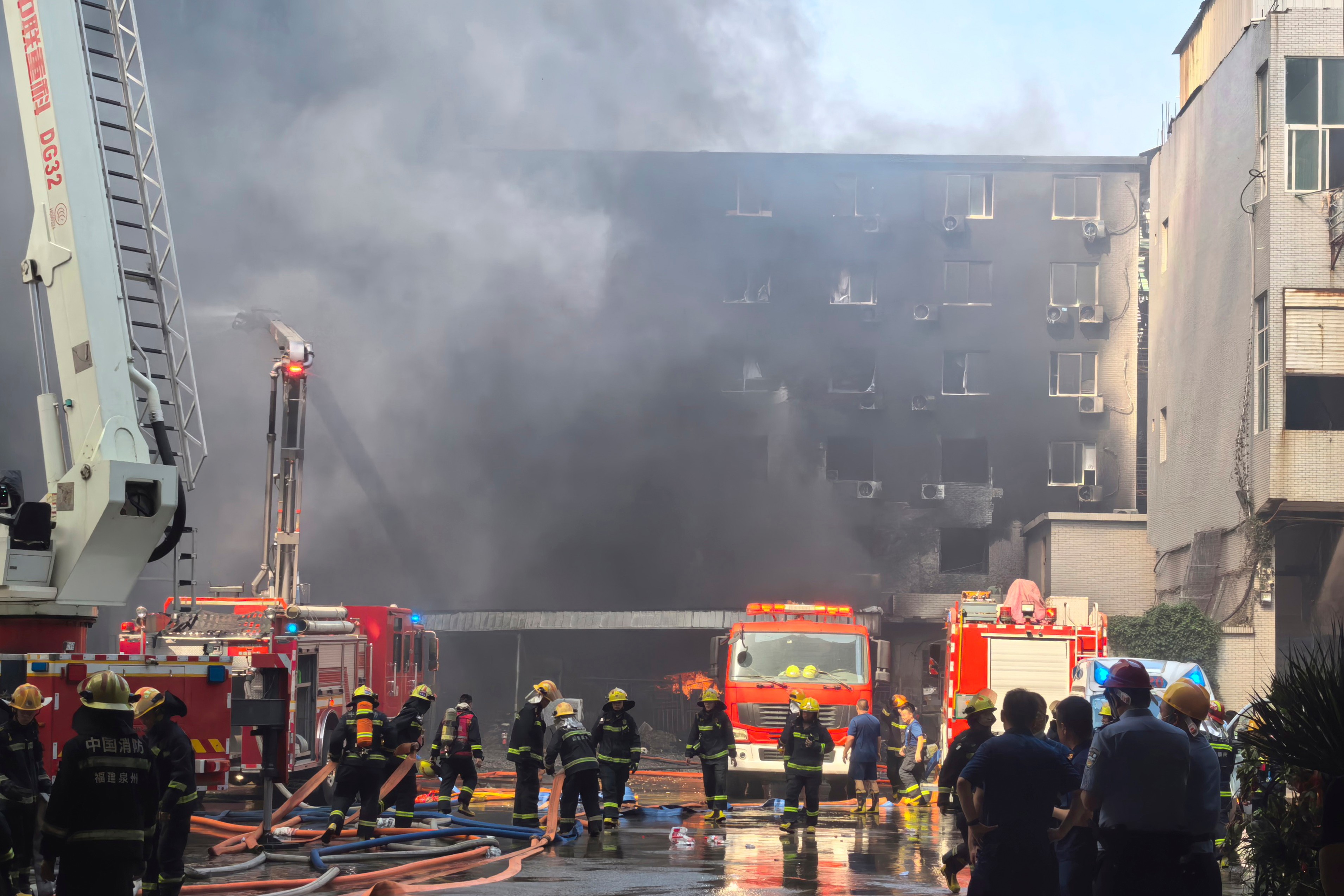 In this photo released by Xinhua News Agency, firefighters at the scene of a footwear factory fire in Jiangtou village, Chendai township of Jinjiang city, southeastern China's Fujian province, Thursday, July 9, 2026.