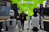 A worker stands near robots at the Nvidia booth during the China International Supply Chain Expo in Beijing on June 22, 2026.
