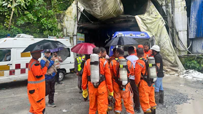 Members of the rescue team carry oxygen cylinders outside the entrance to an under-construction tunnel at a hydropower project in Samardung village, about 40 kilometers (25 miles) from Gangtok, India, Tuesday, July 21, 2026.