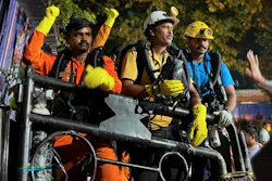 In this image provided by the Information and Public Relations Department, Government of Sikkim, rescue workers stand outside an under-construction tunnel at a hydropower project in Samardung village, about 40 kilometers (25 miles) from Gangtok, India, Wednesday, July 22, 2026.