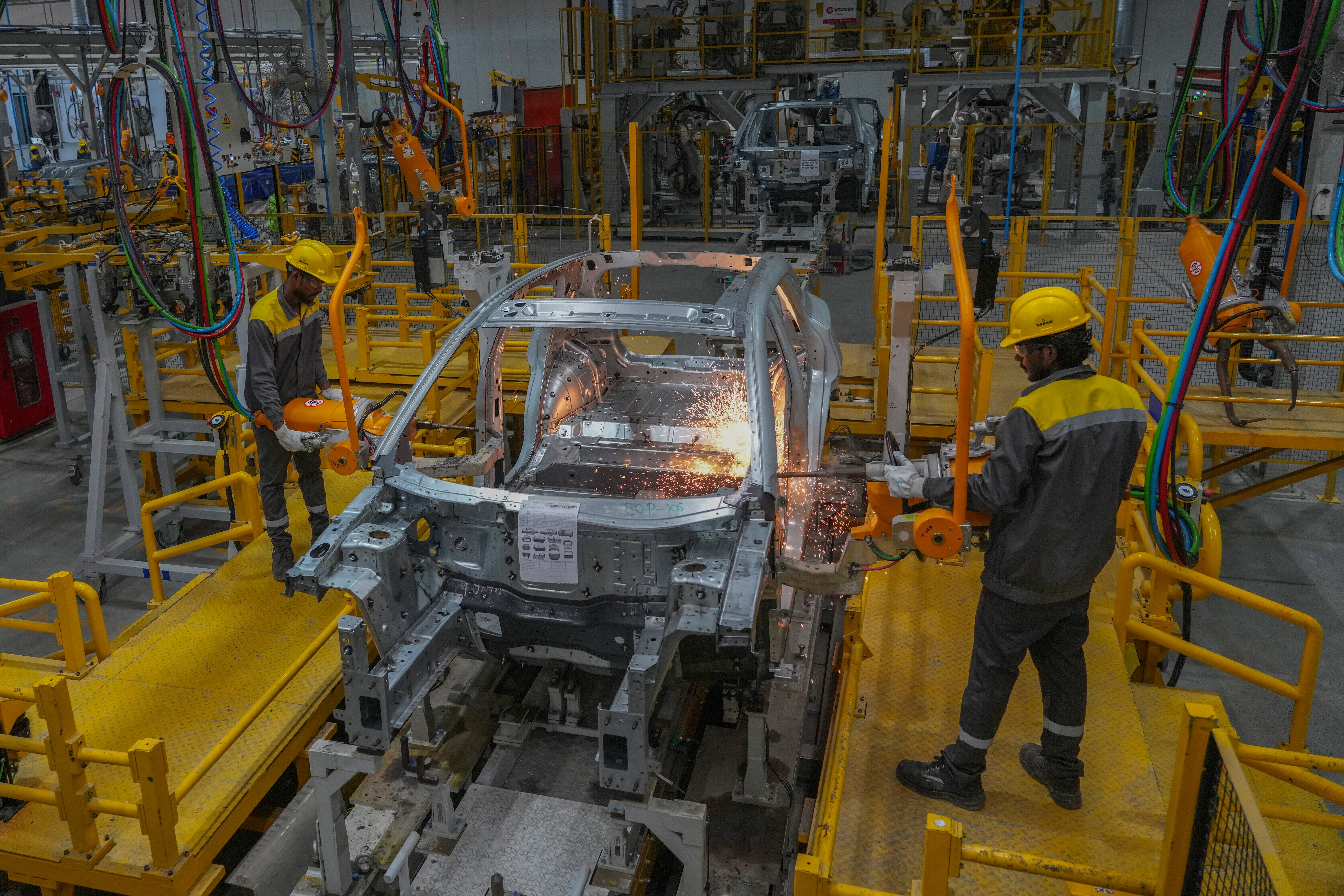 Workers assemble a car at the VinFast electric vehicle plant in Thoothukudi, in the southern Indian state of Tamil Nadu, Monday, Aug. 4, 2025.