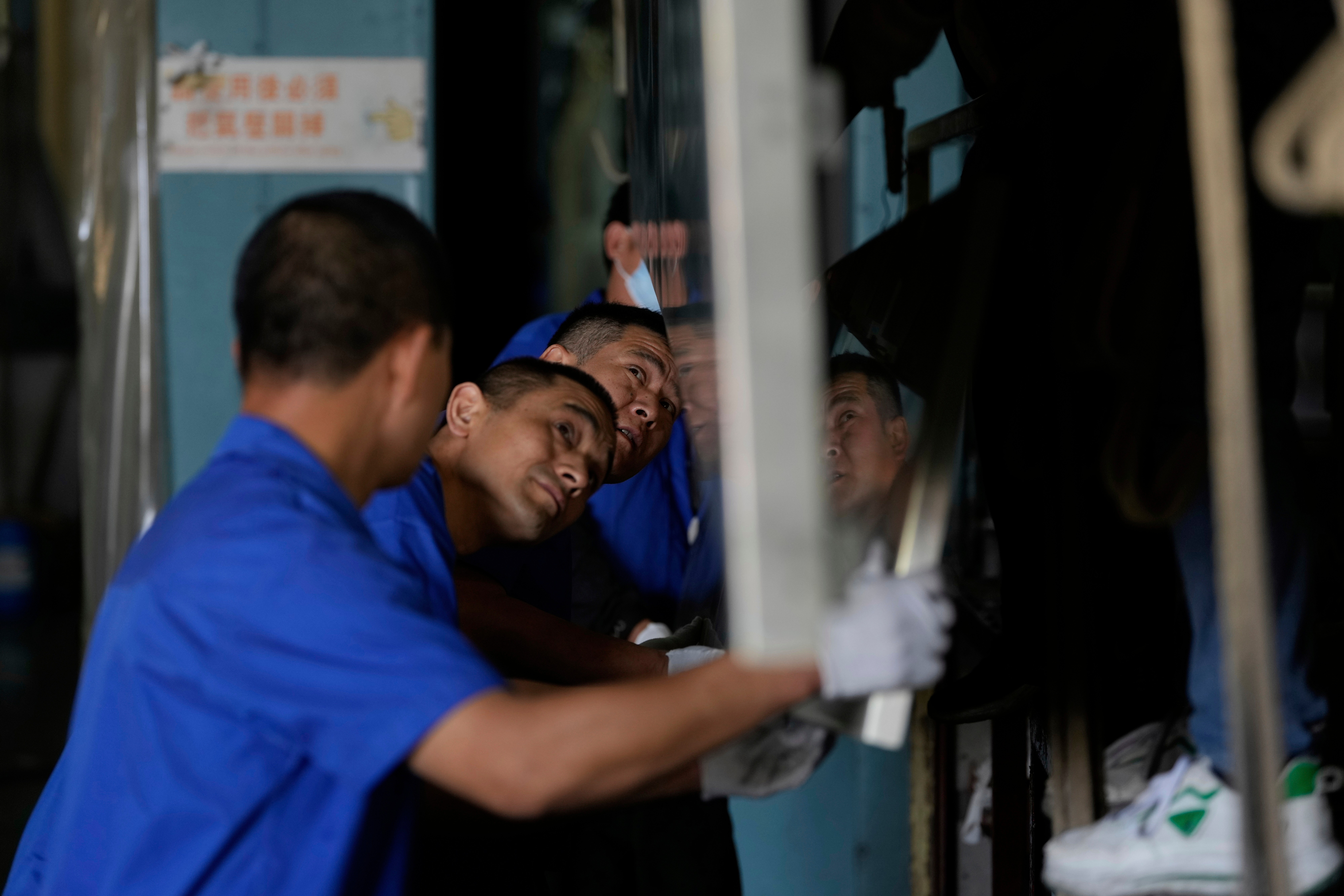 A worker prepares aluminum panels for coating at a factory of Kam Pin Industrial (HK) Ltd., Dongguan, China, April 17, 2025.