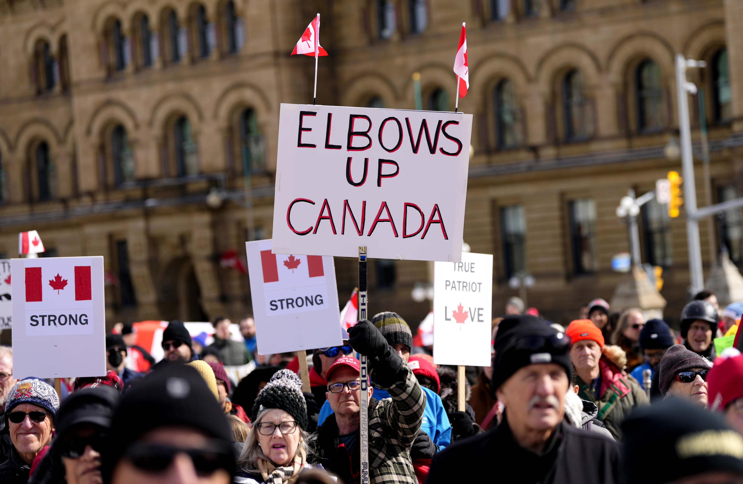 Signs at a rally on Parliament Hill in Ottawa, March 9, 2025.