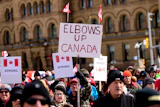 Signs at a rally on Parliament Hill in Ottawa, March 9, 2025.
