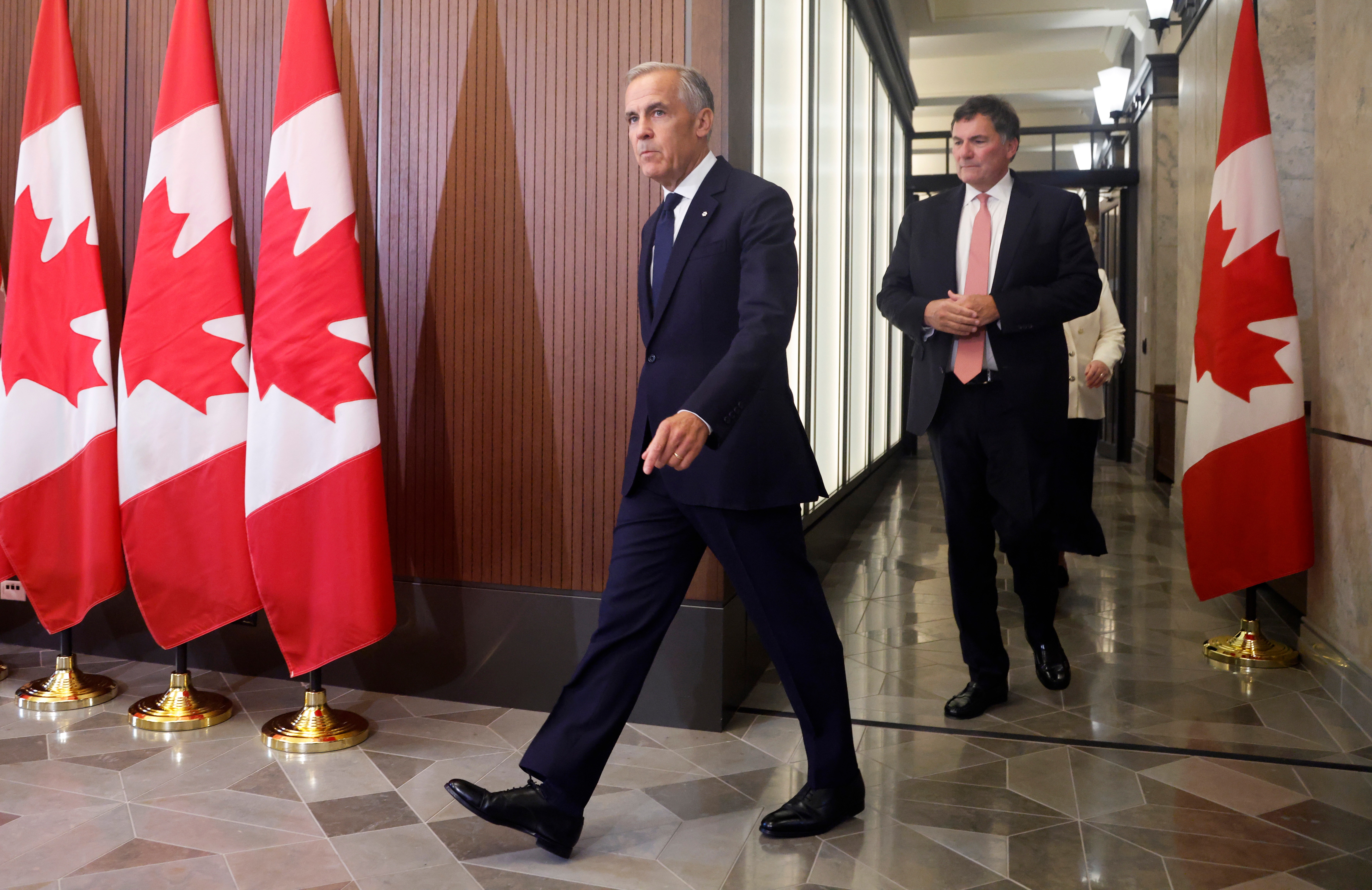Prime Minister Mark Carney and Canada-U.S. Trade Minister Dominic LeBlanc arrive at a news conference on Parliament Hill, Ottawa, Aug. 22, 2026.
