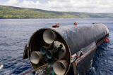 This image provided by SpaceX on Aug. 27, 2026, shows engineers inspecting Starship off the coast of Christmas Island in the Indian Ocean, following its launch on a test flight back in July.