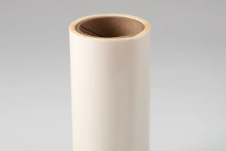 Empty cream-colored cylindrical cardboard tube with brown interior on neutral background