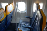 This undated photo provided by the National Transportation Safety Board on Thursday, Aug. 13, 2026, shows the shattered window on a Ryanair plane that was broken by a stray engine part shortly after takeoff, causing a man's head to be sucked into the hole.