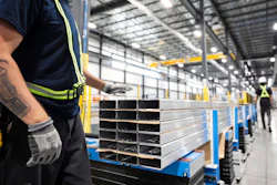 Workers prepare extruded aluminum product for packaging at Magna Aluminum Profile's fully electric powered extrusion facility in Salaberry-de-Valleyfield, Quebec, Canada, on Sept. 3, 2025.