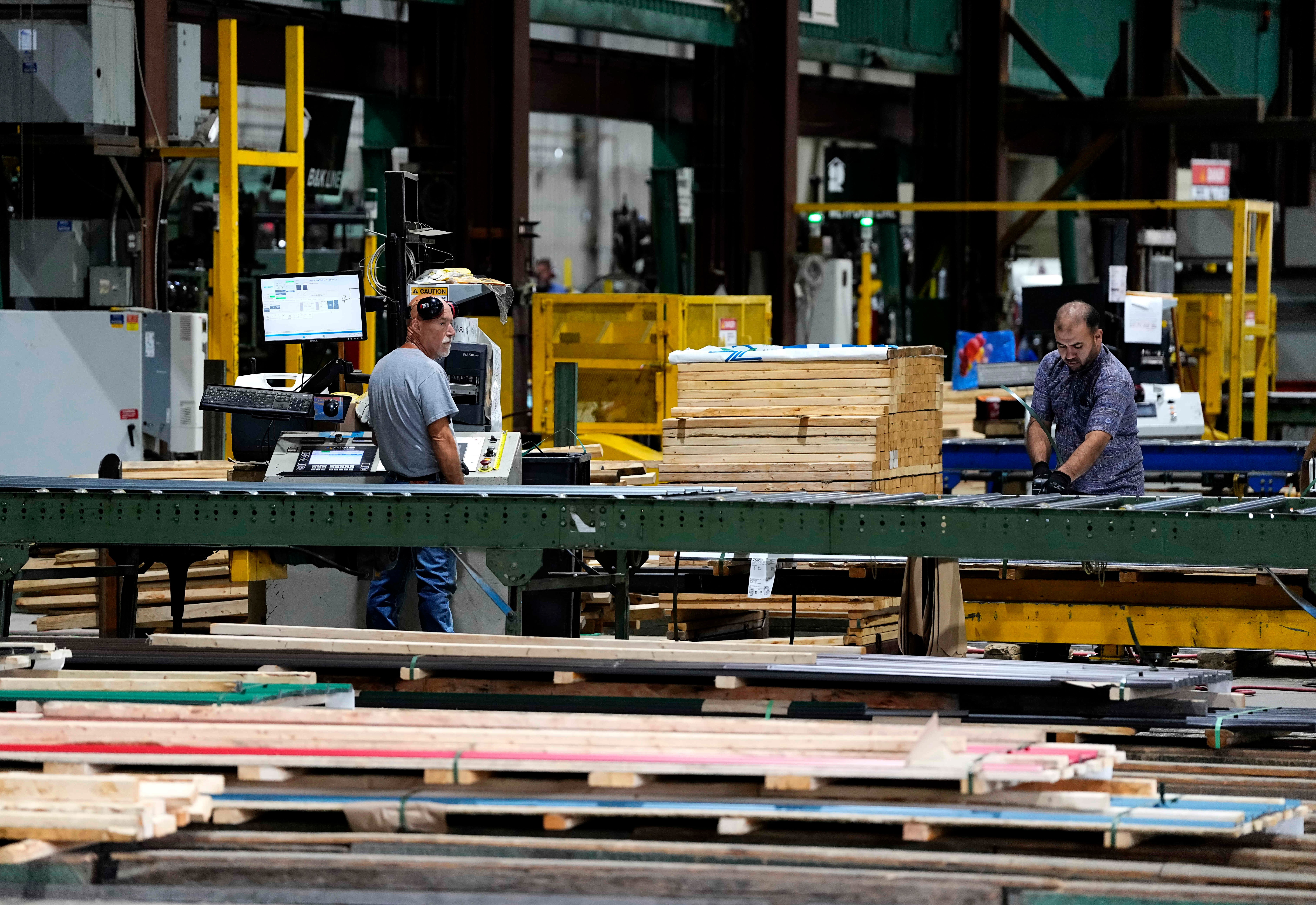 Workers in the manufacturing plant of Ideal Roofing, Ottawa, Aug. 25, 2026.