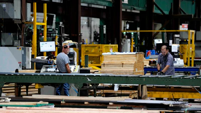 Workers in the manufacturing plant of Ideal Roofing, Ottawa, Aug. 25, 2026.