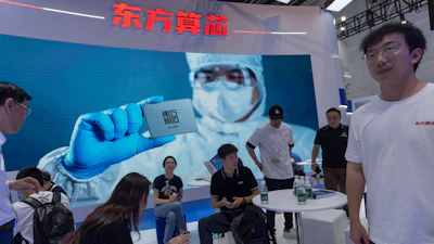 People visit the booth for Chinese AI-computing chip start up Dongfang Suanxin during the World AI Conference in Shanghai, July 17, 2026.