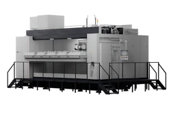 Industrial CNC machining center with gray housing, control panel, and black platform base