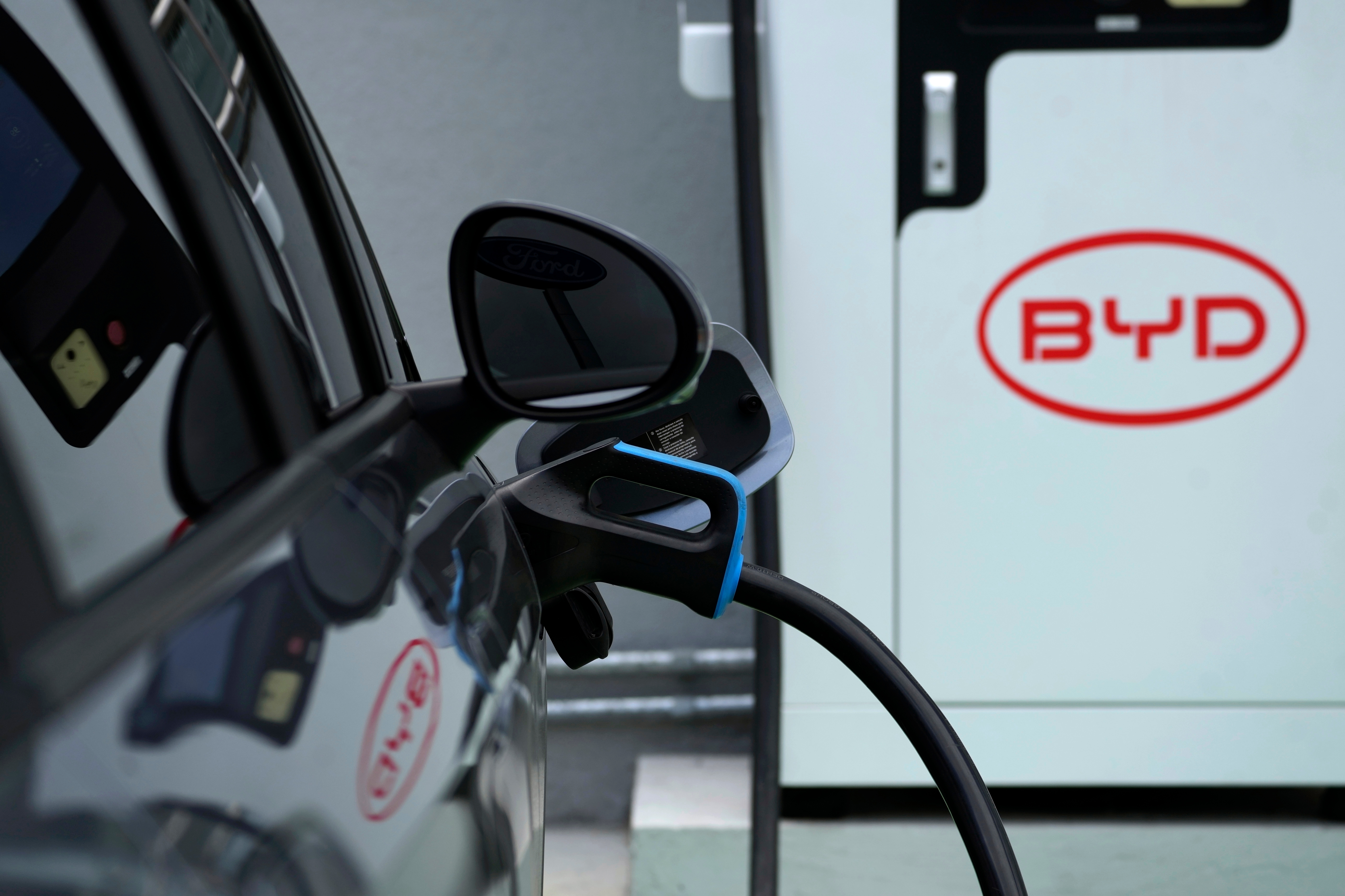 A BYD electric vehicle charges at a dealership in Camacari, Bahia state, Brazil, Friday, March 7, 2025.
