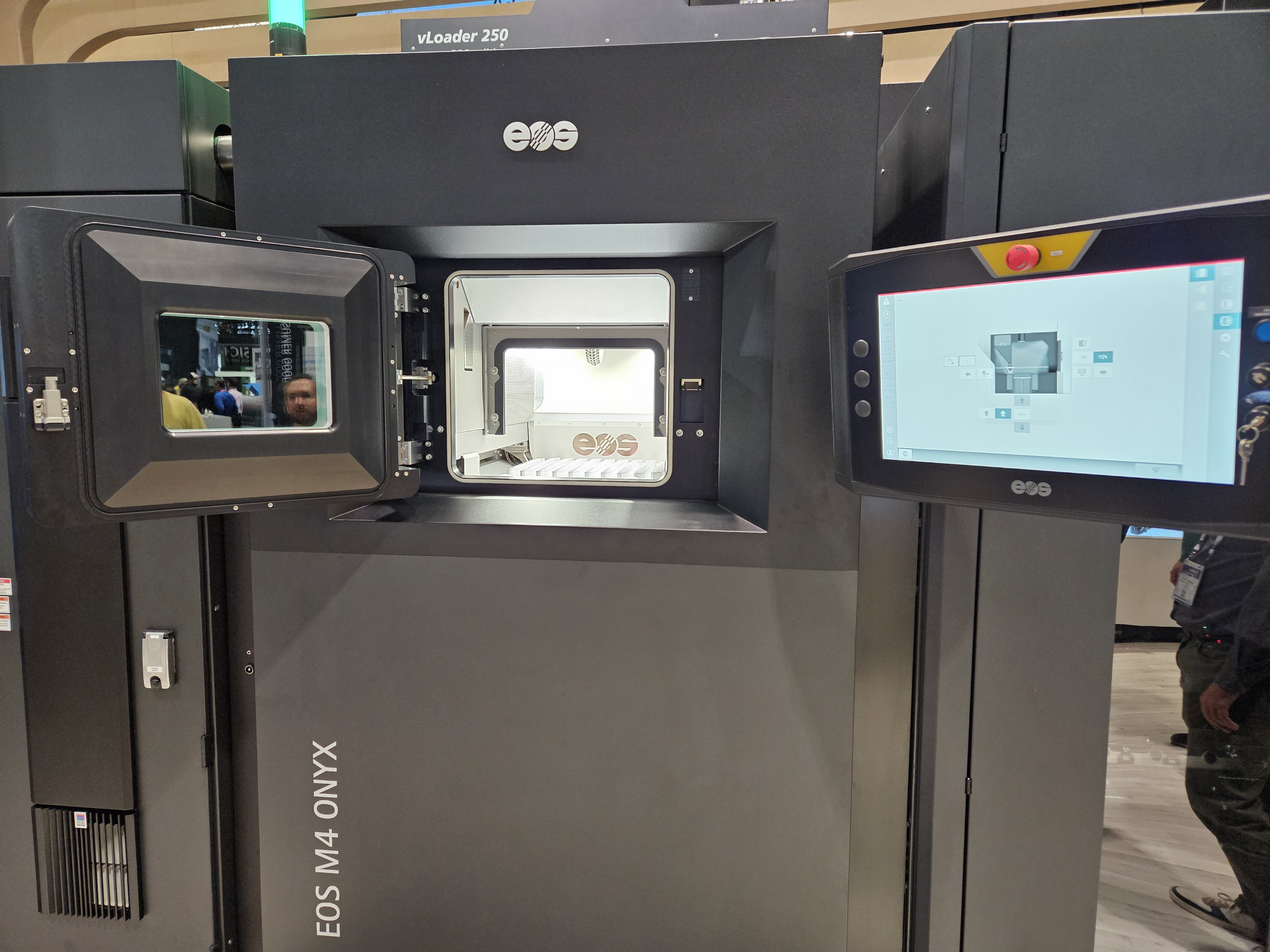 3D printer with open chamber displaying printing platform and control interface