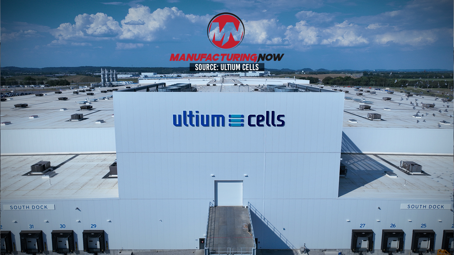 Aerial view of Ultium Cells manufacturing facility with branded signage and loading docks under blue sky