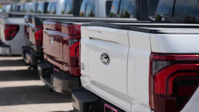 Unsold 2026 F-150 pickup trucks sit in a long line outside a Ford dealership on April 12, 2026, in Centennial, Colo.