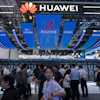 Visitors past by the Huawei booth display of the Atlas 950 SuperPoD during the World AI Conference in Shanghai, China on Friday, July 17, 2026.