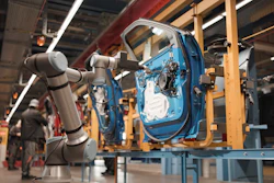 Robotic arms assembling blue car door on factory assembly line