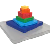 Colorful stacking toy blocks arranged in pyramid formation on gray base platform