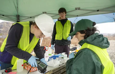 Catherine Armbruster, left, measures the levels of gases released by the soil’s chemical pollutants.